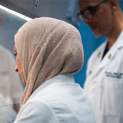 Doctors looking at research lab desk