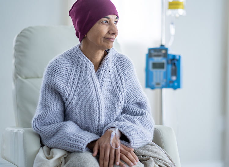 patient sitting in a chair receiving chemotherapy treatment